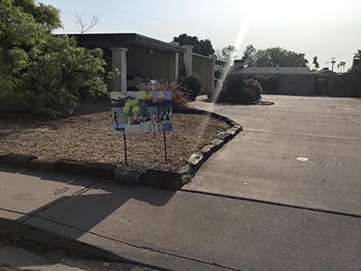 Exterior of home, with potluck sign
