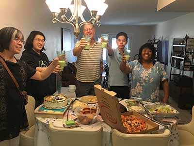 Guests holidng non-alcoholic pina coladas at birthday party for Kai