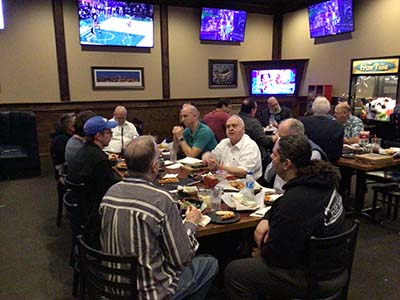Men eating pizza at Guys Night Out at Barro's Pizza - 2 December 2022