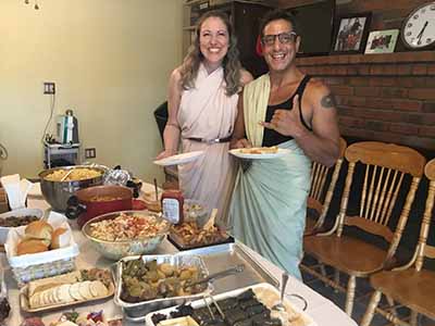 Christine and Javier dressed in Greek robes