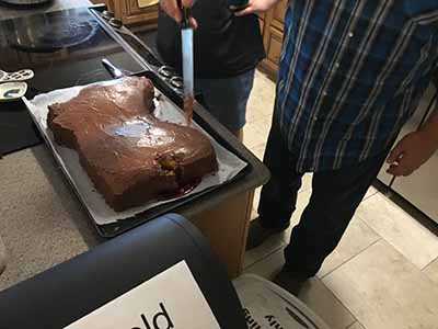 cutting into severed horse head cake