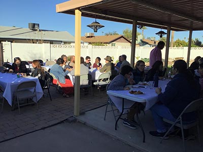 people at Thanksgiving Day potluck dinner
