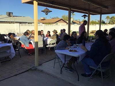 people at Thanksgiving Day potluck dinner
