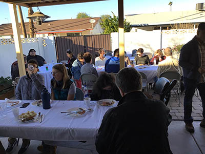 people at Thanksgiving Day potluck dinner