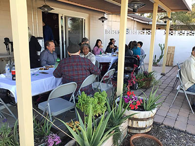 people at Thanksgiving Day potluck dinner