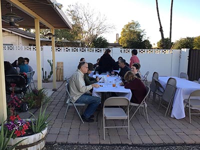 people at Thanksgiving Day potluck dinner