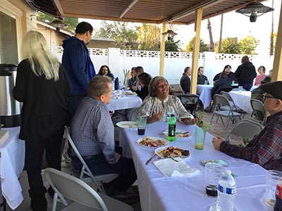 people at Thanksgiving Day potluck dinner
