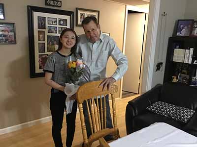 Joseph giving flowers to student