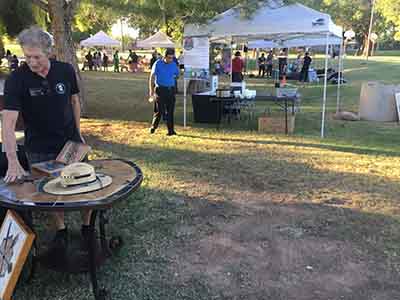 artist and tent behind him