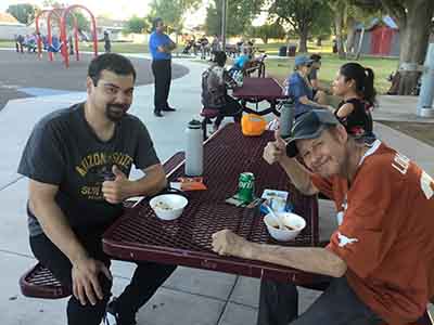 Dominik and Joseph sitting at picnic table