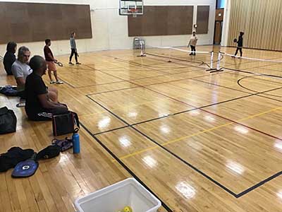 neighbors playing pickleball