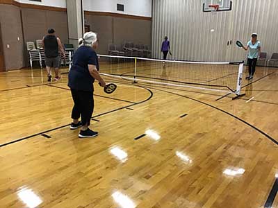 neighbors playing pickleball