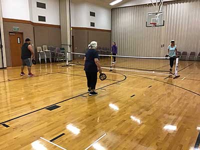 neighbors playing pickleball