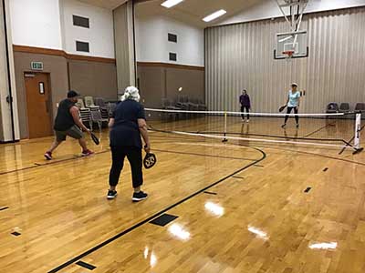 neighbors playing pickleball