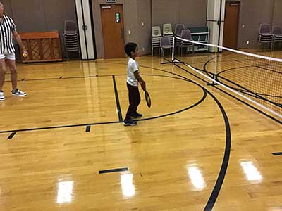 neighbors playing pickleball