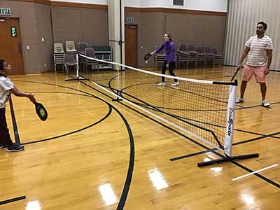 neighbors playing pickleball