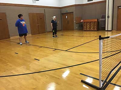 neighbors playing pickleball