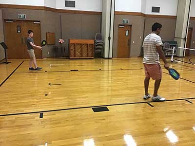neighbors playing pickleball