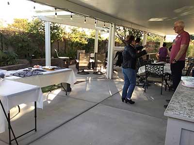people at potluck dinner in back yard