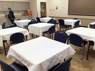 tables with white tablecloths on them
