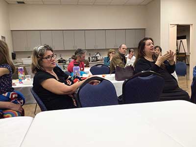 neighbors listening to Hungarian parliamentarians addressing group