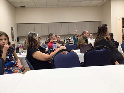 neighbors listening to Hungarian parliamentarians addressing group