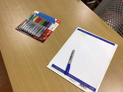 markers and labels for nametags at book club meeting