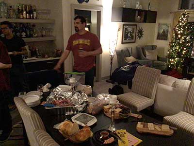 Dominik standing behind table with food