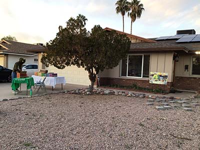 Girl Scout cookie sale and potluck sign in front of house hosting potluck dinner