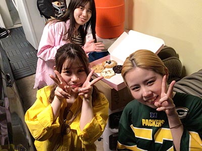 three Japanese ESL students with Crumbl cookies in a box