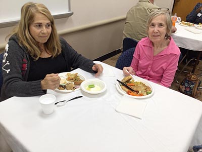 people at potluck dinner