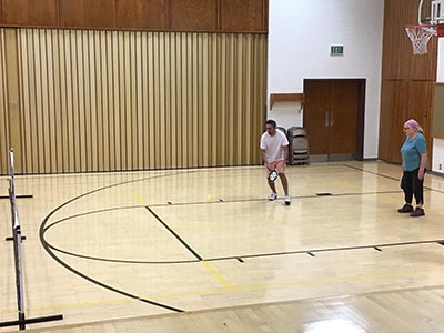 neighbors playing pickleball