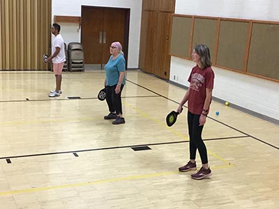 neighbors playing pickleball