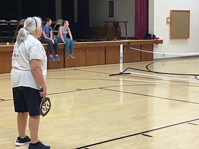 neighbors playing pickleball