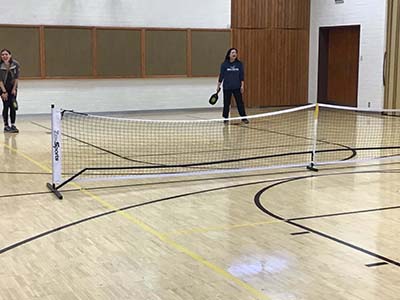 neighbors playing pickleball