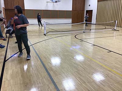 neighbors playing pickleball