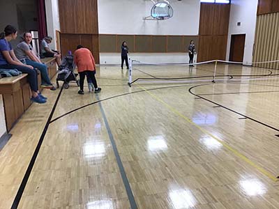 neighbors playing pickleball