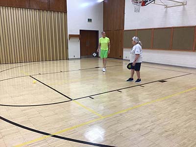 neighbors playing pickleball