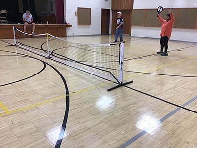 neighbors playing pickleball