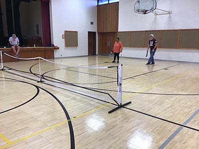 neighbors playing pickleball