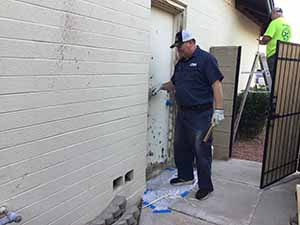 neighbors gather to scrape and paint trim on home of elderly neighbor Nellice Reidhead