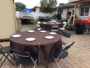 neighbors gather at for Thanksgiving Day potluck dinner