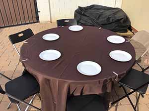 neighbors gather at for Thanksgiving Day potluck dinner