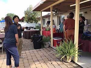 neighbors gather at for Thanksgiving Day potluck dinner