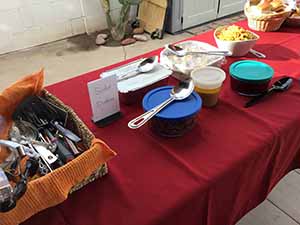 neighbors gather at for Thanksgiving Day potluck dinner