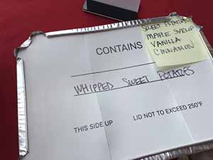 neighbors gather at for Thanksgiving Day potluck dinner