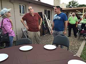 neighbors gather at for Thanksgiving Day potluck dinner
