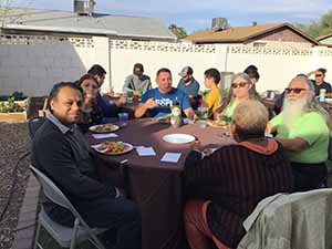 neighbors gather at for Thanksgiving Day potluck dinner