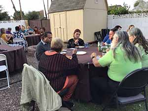 neighbors gather at for Thanksgiving Day potluck dinner