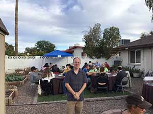 neighbors gather at for Thanksgiving Day potluck dinner